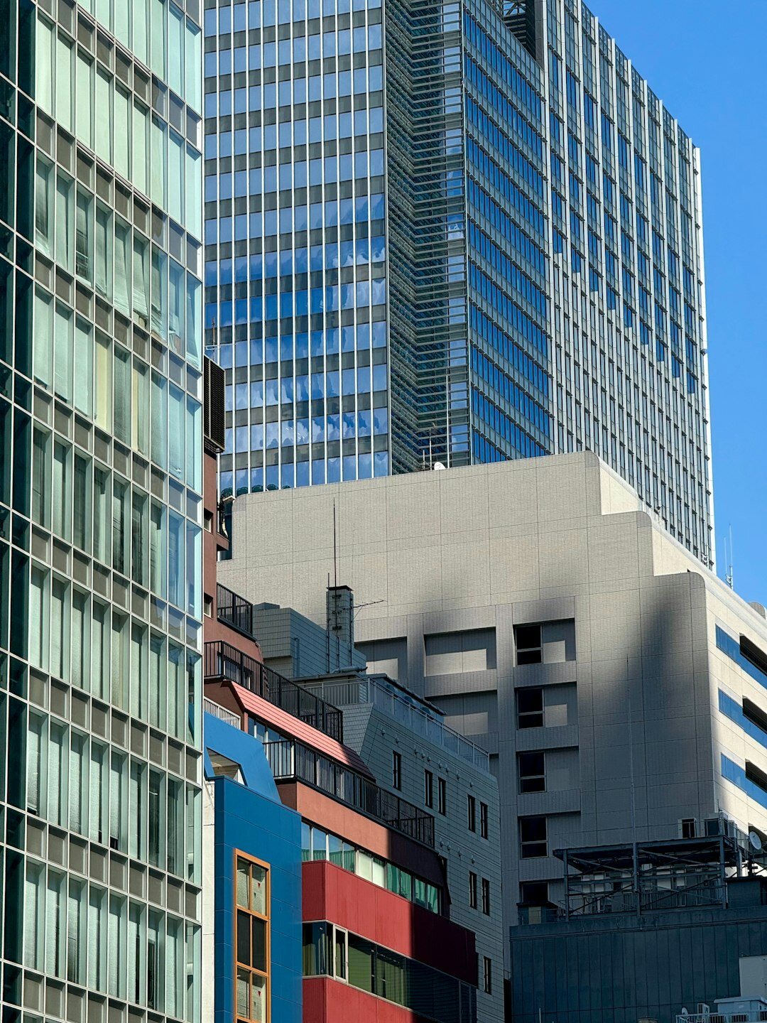 Exterior view of a modern glass office building in Tokyo