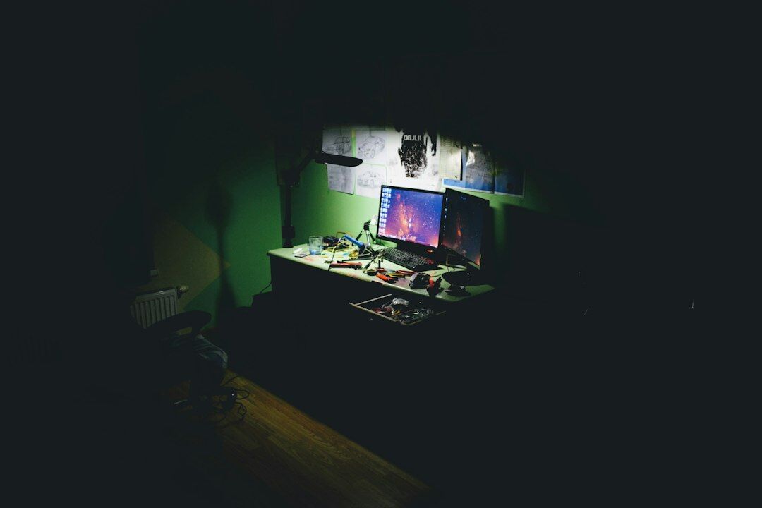 Japanese software developer writing code on a desktop monitor
